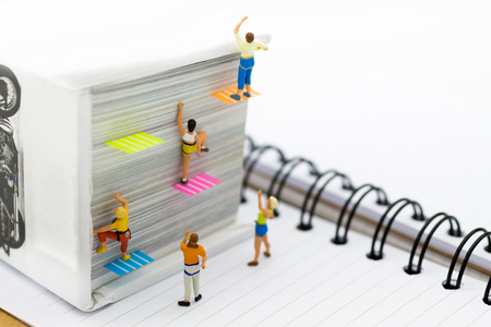 Miniature people: Climber climbing on book . Image use for learning, education concept.の写真素材