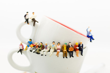 Miniature people : Business team sitting on cup of coffee and having a coffee break. Image use for business concept.の写真素材