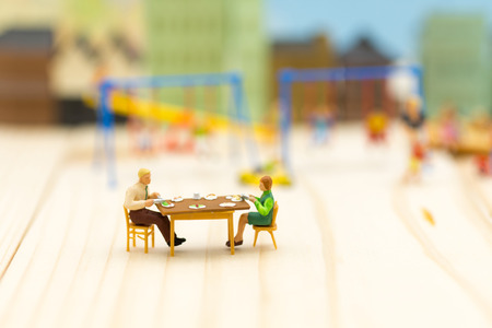 Miniature Families are celebrating , eating together happily. Used in the concept of family festival.の写真素材