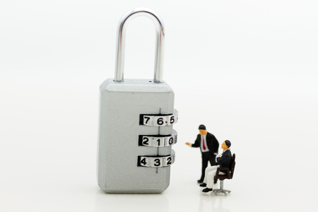 Miniature people:  Businessman looking for password of security key. Image use for background security system, hack, business concept.の写真素材