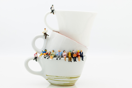Miniature people : Business team sitting on cup of coffee and having a coffee break. Image use for business concept.の写真素材