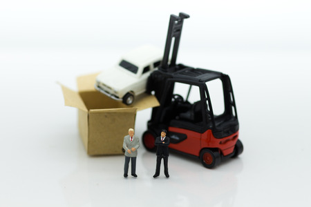 Miniature people : Man of auto insurance when an accident on the road. Image use for Make an agreement, responsibility, business concept.の写真素材