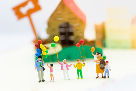 Miniature family: Childrens holding balloon playing together. Image use for background International day of families concept.の写真素材