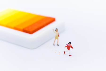 Miniature people: Children naughty running on trace . Image use for  learning go around, education concept.の写真素材