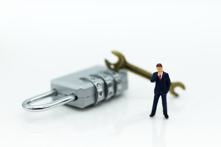 Miniature people:  Businessman with security key. Image use for background security system, hack, business concept.の写真素材