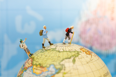 Miniature people: Group traveler backpack stand and walking on world map. Image use for travelling or business trip concept.の写真素材