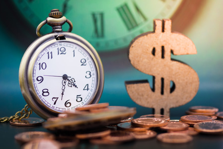 Pocket watch and stack of coins, wooden dollar. Image use for sale background, buy, trade, deal, business time concept.の写真素材