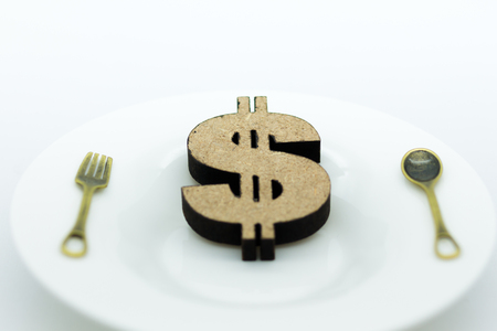 Wooden dollar, fork and spoon put on dish. Image use for business background  concept.の写真素材