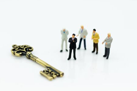 Miniature people: Group Businessmen stand with master key. Image use for key man, the key to success, business concept.の写真素材