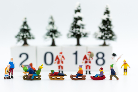 Miniature people: Children playing on snow funny together. Image use for Christmas festivalの写真素材