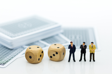 Miniature people: Businessman with paper and dice . Image use for risk of business concept.の写真素材