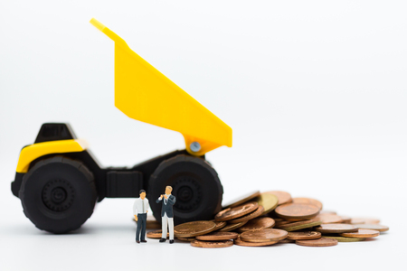 Dump truck pouring coins. Image use for money and business financial concept.の写真素材