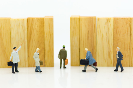 Miniature people : Businessmen are walking to the exit point. Image use for the best choice of choose, business concept.の写真素材