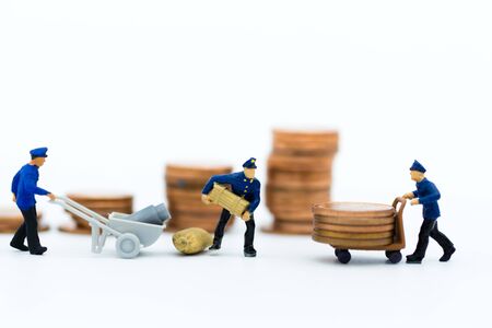 Miniature people : Workers are lifting their crate onto a pushcart. Image use for business concept.