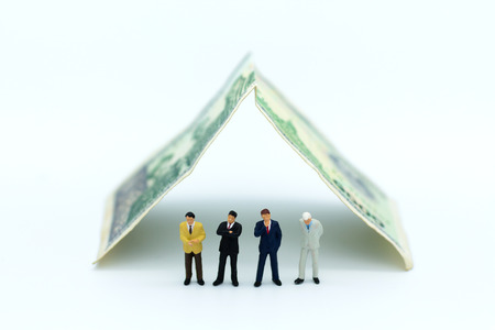 Miniature people: Businessman with money. Image use for business real estate investment conceptの写真素材