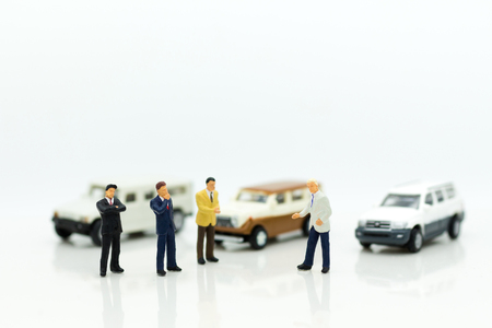 Miniature people : Businessman standing with car. Image use for Advertising product in the market today, competition on the business trading.の写真素材