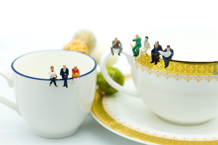 Miniature people : Business team sitting on cup of coffee and having a coffee break. Image use for business concept.の写真素材