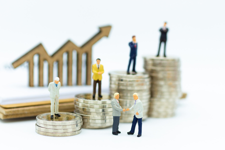 Miniature people : Businessman team standing on stack of coin. Image use for financial, business vision concept.の写真素材