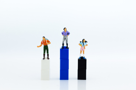 Miniature people : Tourist walking on colorful block podium. Image use for travel concept.の写真素材