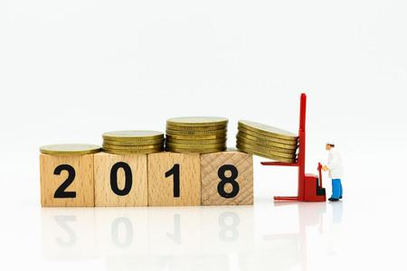 Miniature people: Worker use pallet truck with stack of coins. Image use for background business...