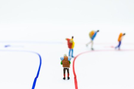 Miniature people : Backpacker walking follow arrow. Image use for travel, business concept.の写真素材