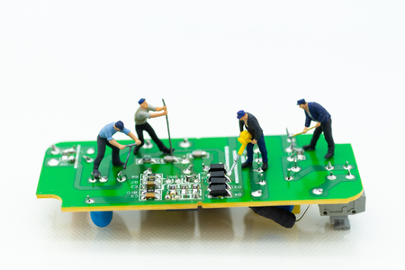 Miniature worker repairing mainboard, clear virus computer and repair, security and technology concept.の写真素材