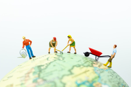Miniature people: The villagers are farming on the globe. Image use for Industrial and agricultural.