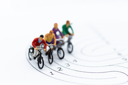 Miniature people : Cycling on the track. Image use for Competition of the current society.の写真素材