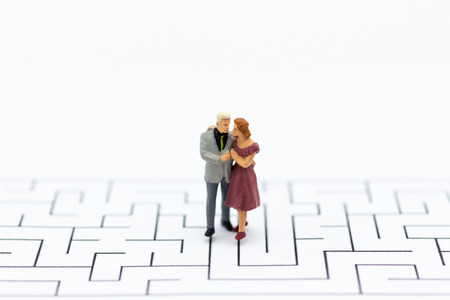 Miniature people : Couple standing on maze. Image use for Living together, breaking through barriers, family concept.の写真素材