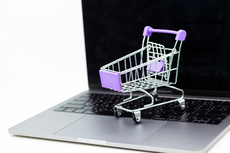 Shopping cart for retail business on notebook. Image use for online and offline shopping, marketing place world wide.の写真素材