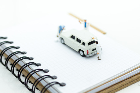 Miniature people : Workers make up the car. Image use for cleaning and maintenance, business autocar concept.の写真素材