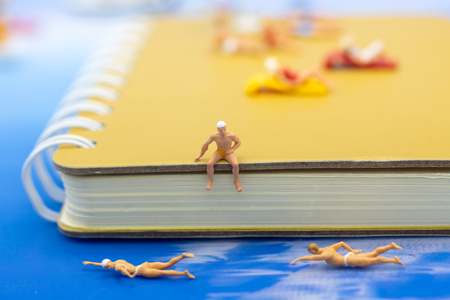 Miniature people : Tourists are swimming on blue ocean. Image use for sport, vacation ,travel concept.の写真素材