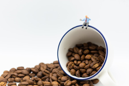 Miniature people : Business team sitting on cup of coffee and having a coffee break. Image use for business concept.の写真素材