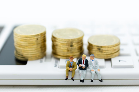 Miniature people: Businessman sitting on calculator. Image use for investment, tax, business...