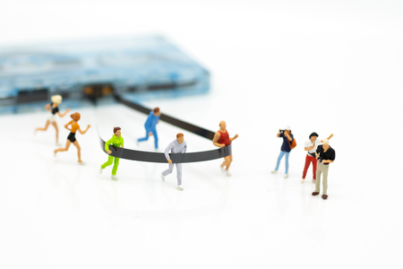 Miniature people running to tape cassette for winner . Image use for healthy , exercise concept.の写真素材