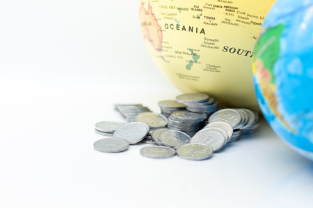 Stack of coin beside the world map. Image use for investment, business international concept.の写真素材