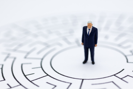 Miniature people : Businessmen in the maze. Image use for to solve problems, finding solution and...