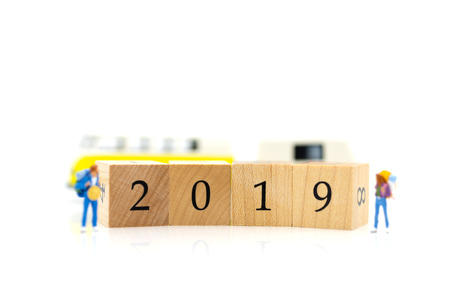 Miniature people, group travelers standing on wooden block 2019, new year. Image use for travel business concept.の写真素材