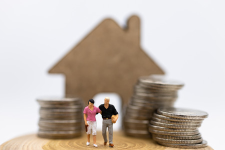 Miniature people : Couple standing area front of house.  Image use for Valentine's day , planning...