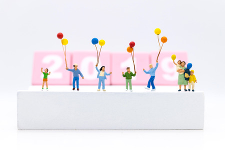 Miniature family, children holding colorful balloon. Image use for background International day of...