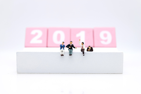 Miniature people : Businessman sitting on wooden block 2019. Image use for business concept.の写真素材
