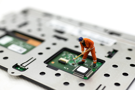 Miniature people: Worker repairing circuit board ,electronics repair. Use image for support and maintenance business.の写真素材