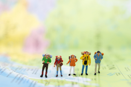 Miniature people : traveler walking on the map. Used to travel to destinations on travel business background concept.の写真素材