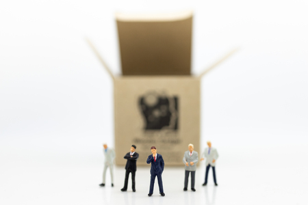 Miniature people: Businessman stand front of  money box, profit margins of  background, risk. Image use for business solution concept.の写真素材