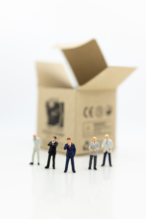 Miniature people: Businessman stand front of  money box, profit margins of  background, risk. Image use for business solution concept.の写真素材