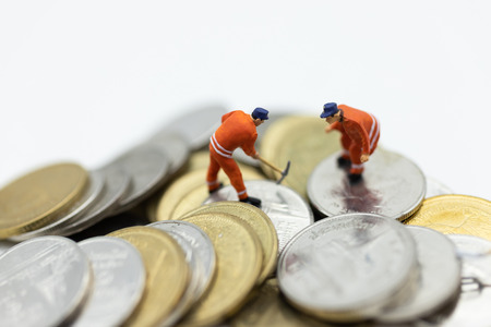 Miniature people: Worker working on stack of coins, income from work. Image use for business concept.の写真素材