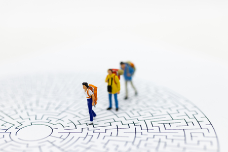 Miniature people: Tourists walk on the maze map. Image use for tourism campaign, spending money, holiday concept.の写真素材