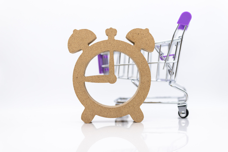 Shopping cart and wooden watch ,image use for discount period for shopping ,special price, sold out, business marketing conceptの写真素材