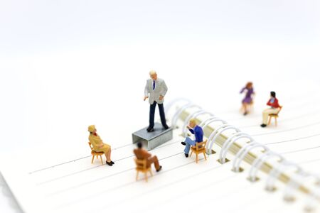 Miniature people: Businessman looking for employees for job placement. Image use for choice of the best suited employee, job recruiter concepts.の写真素材
