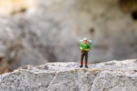Miniature people : traveler walking on the road. Used to travel to destinations on travel business background concept.の写真素材